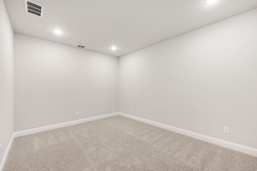 Empty room with white walls, beige carpet, recessed lighting, and white baseboards Empty room with white walls, beige carpet, recessed lighting, and white baseboards