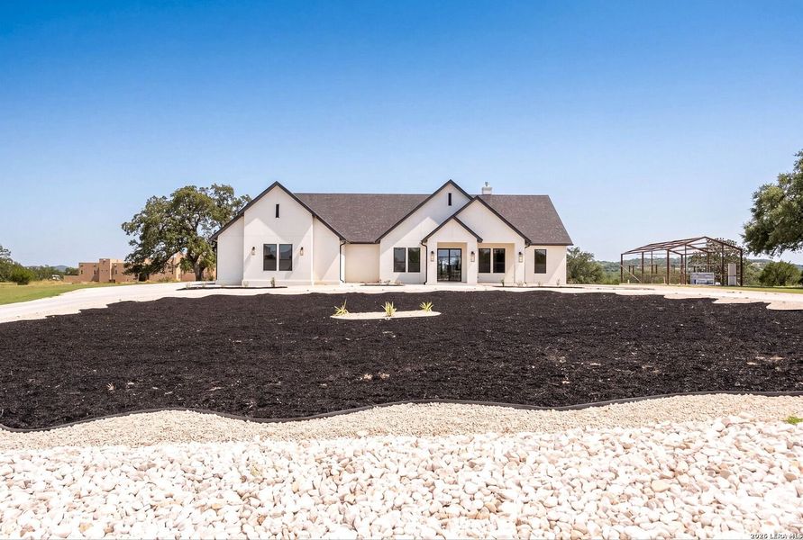 Front exterior of a new home in , Bandera, TX, highlighting curb appeal (Image 28). Front exterior of a new home in , Bandera, TX, highlighting curb appeal (Image 28).