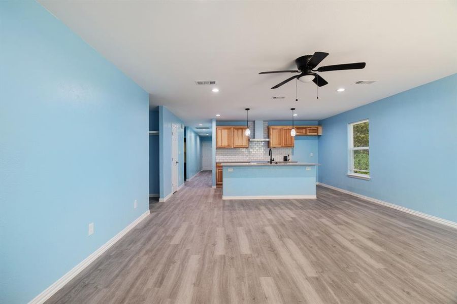 Unfurnished living room with light wood-style flooring, recessed lighting, and ceiling fan Unfurnished living room with light wood-style flooring, recessed lighting, and ceiling fan