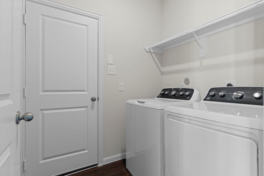 Convenient utility room with washer and dryer included! Designed for function and style, this space features built-in shelving for storage and easy access to the main living areas—making laundry days simple and efficient! Convenient utility room with washer and dryer included! Designed for function and style, this space features built-in shelving for storage and easy access to the main living areas—making laundry days simple and efficient!