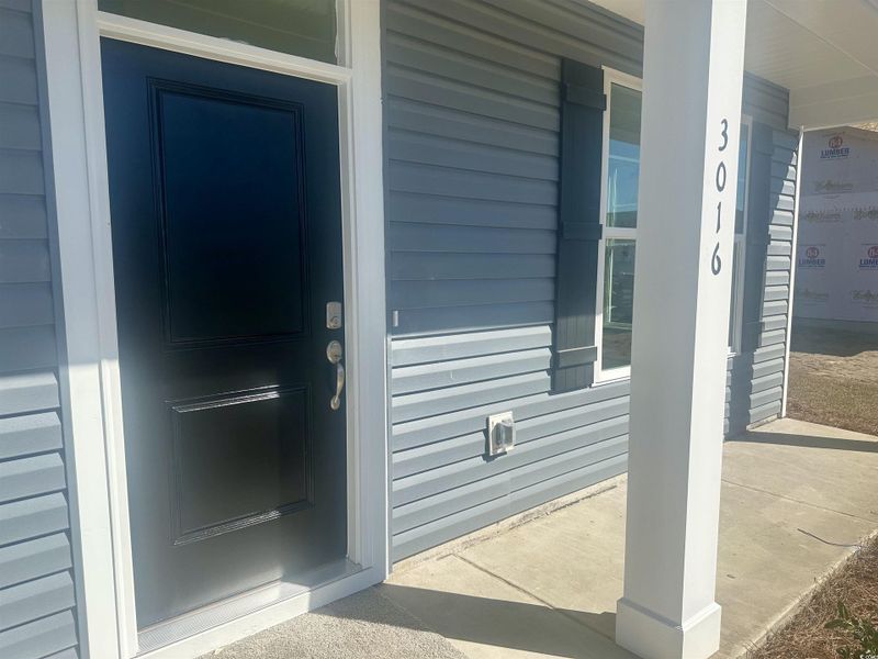 Property entrance with covered porch Property entrance with covered porch