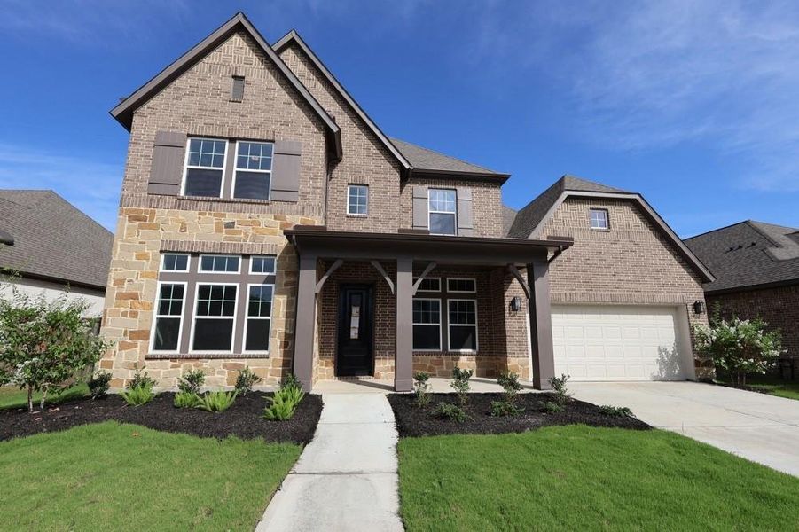 Front exterior of a new home in Riceland 60’ Homesites, Mont Belvieu, TX, highlighting curb appeal (Image 20).