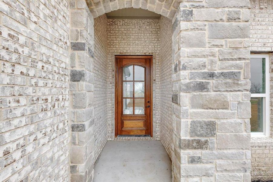 Entrance to property with stone siding