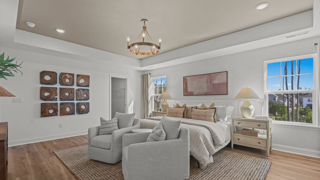 Wynwood home plan expansive primary suite with tray ceiling, sitting room, walk-in closet, and luxury en suite bathroom Wynwood home plan expansive primary suite with tray ceiling, sitting room, walk-in closet, and luxury en suite bathroom