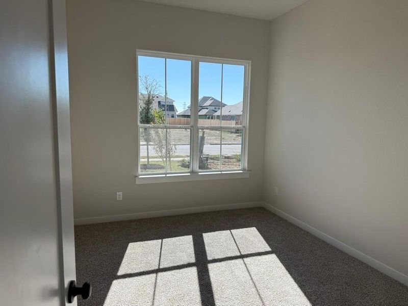 Carpeted empty room with baseboards