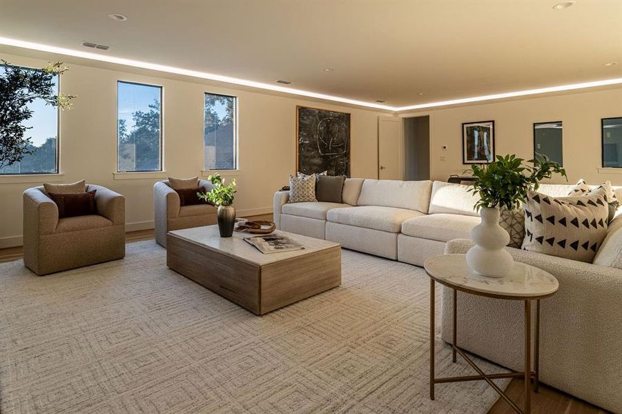 Living area with wood finished floors and recessed lighting