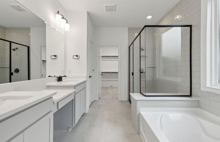 Elegant owner's bathroom with dual vanity and oversized shower*real home pictured