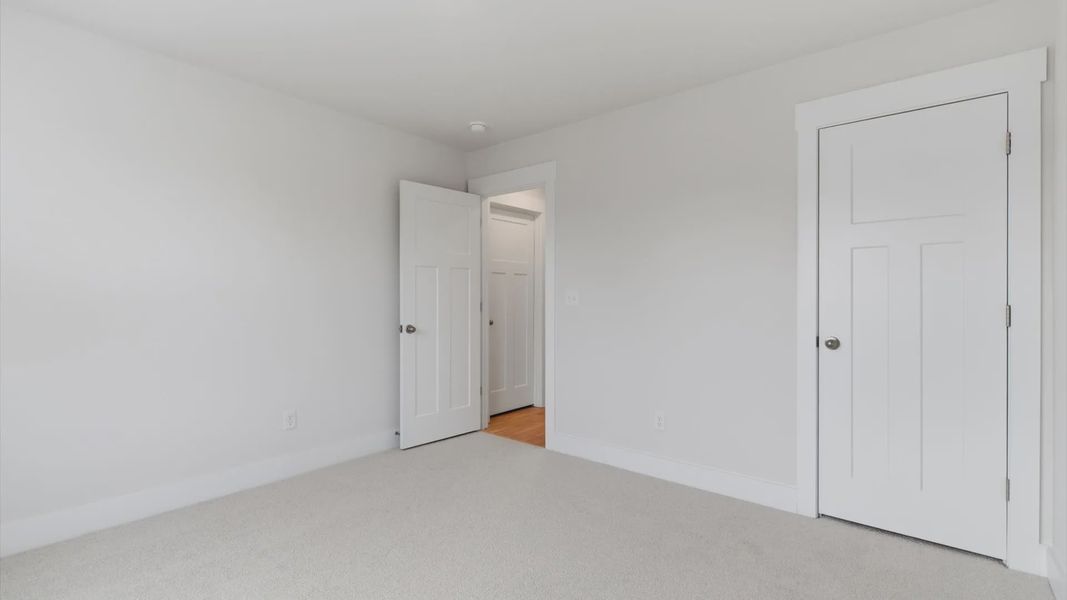 First-rate secondary bedroom with a spacious walk-in closet and elegant carpeted flooring located in Greenville, SC