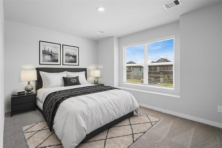 This secondary bedroom features custom paint, plush carpet, and a large window with privacy blinds!