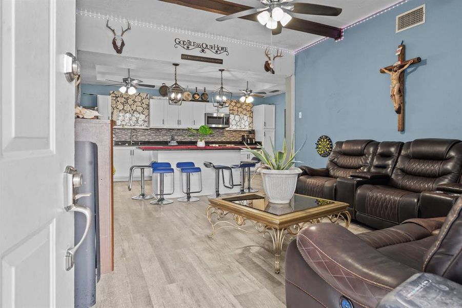 Living room with light hardwood / wood-style flooring