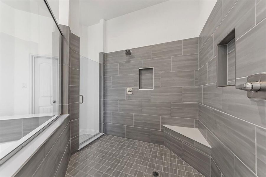 Full bathroom with a shower stall and tile patterned flooring