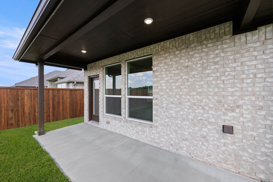 Exterior details and patio area of a home in Meadow Park at The Meadows, Ponder (Image 3).