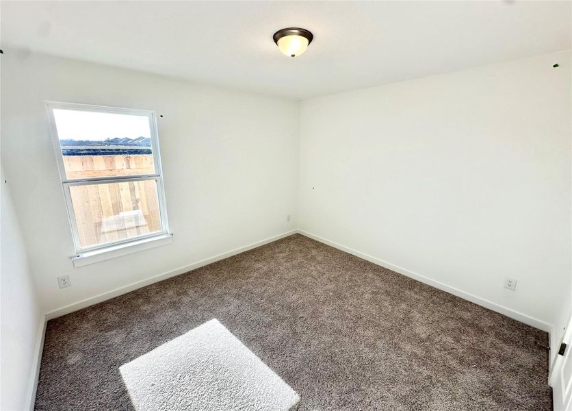 Unfurnished room featuring carpet floors and baseboards