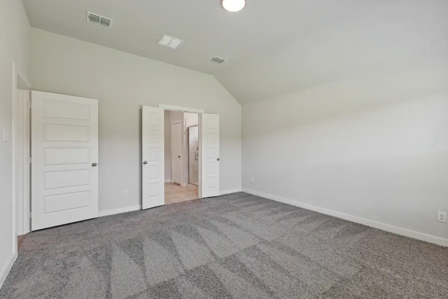Primary bedroom in the Quartz home plan by Trophy Signature Homes – REPRESENTATIVE PHOTO
