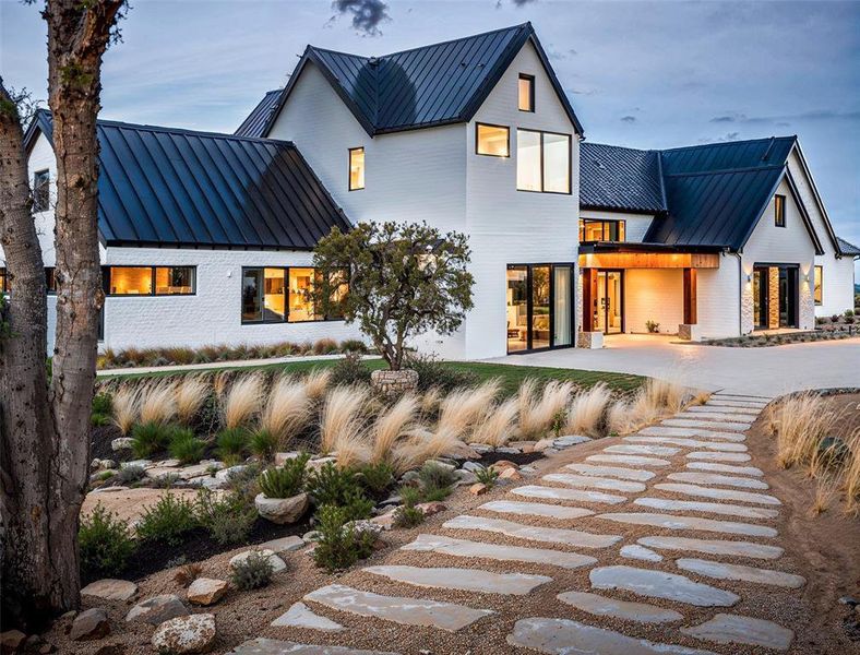 Back of property featuring metal roof and a standing seam roof