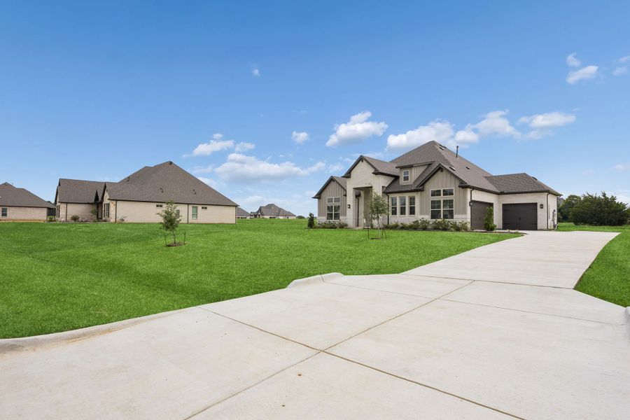 Front exterior of a new home in Joshua Meadows, Joshua, TX, highlighting curb appeal (Image 20). Front exterior of a new home in Joshua Meadows, Joshua, TX, highlighting curb appeal (Image 20).