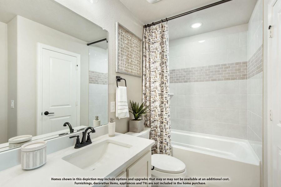 Bathroom with white vanity, tub-shower combo with tile surround, and patterned curtain Bathroom with white vanity, tub-shower combo with tile surround, and patterned curtain