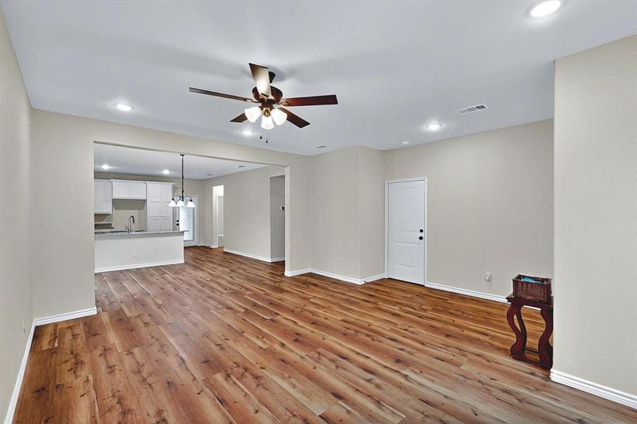 Unfurnished living room with visible vents, wood finished floors, baseboards, ceiling fan, and recessed lighting Unfurnished living room with visible vents, wood finished floors, baseboards, ceiling fan, and recessed lighting