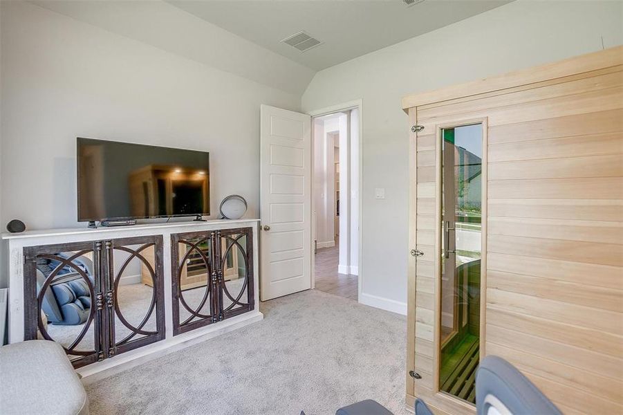 Living area featuring carpet floors, baseboards, and lofted ceiling Living area featuring carpet floors, baseboards, and lofted ceiling