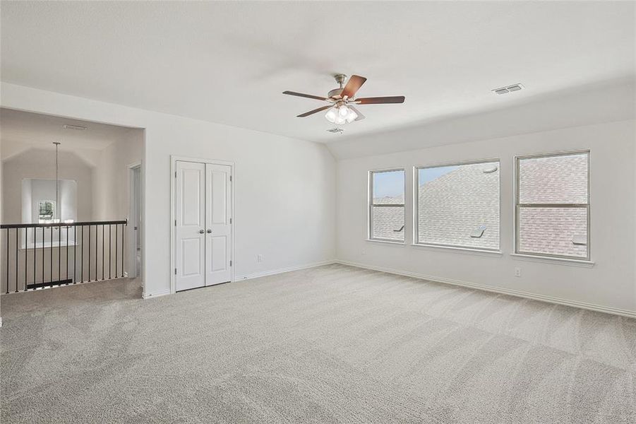 Unfurnished room with carpet, lofted ceiling, and ceiling fan