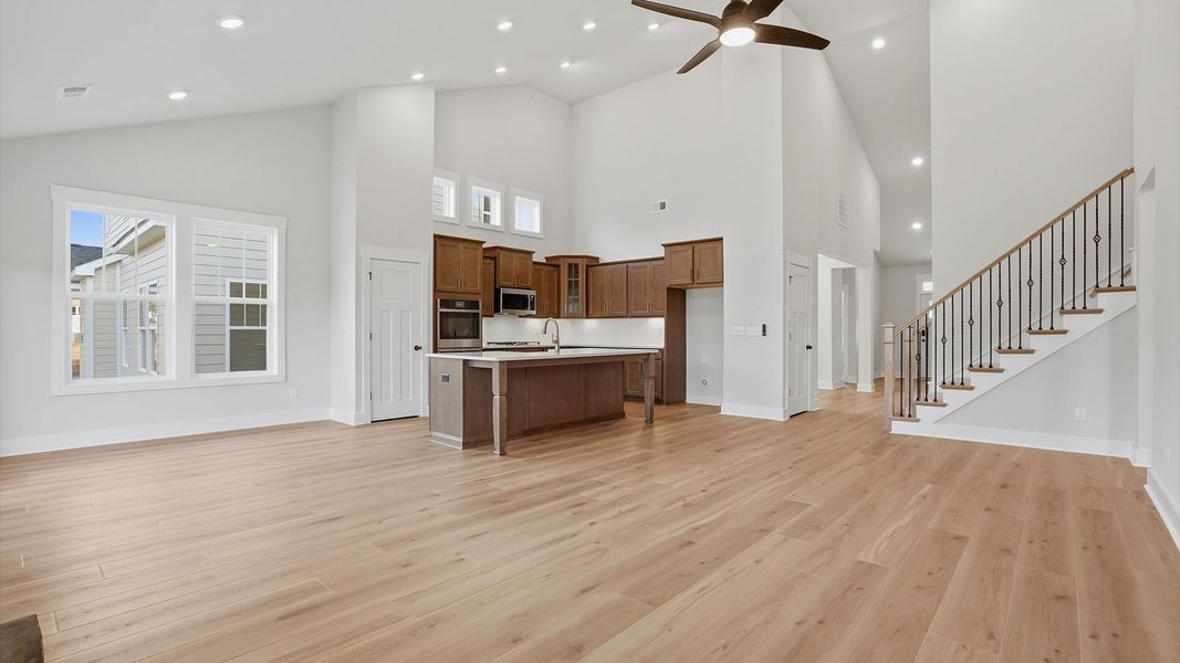 Refined and memorable, this family room features two-story ceilings and top-notch comfort throughout