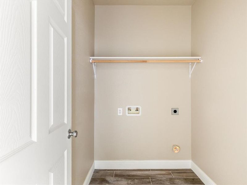 Laundry area featuring electric dryer hookup, washer hookup, and wood tiled floors Laundry area featuring electric dryer hookup, washer hookup, and wood tiled floors