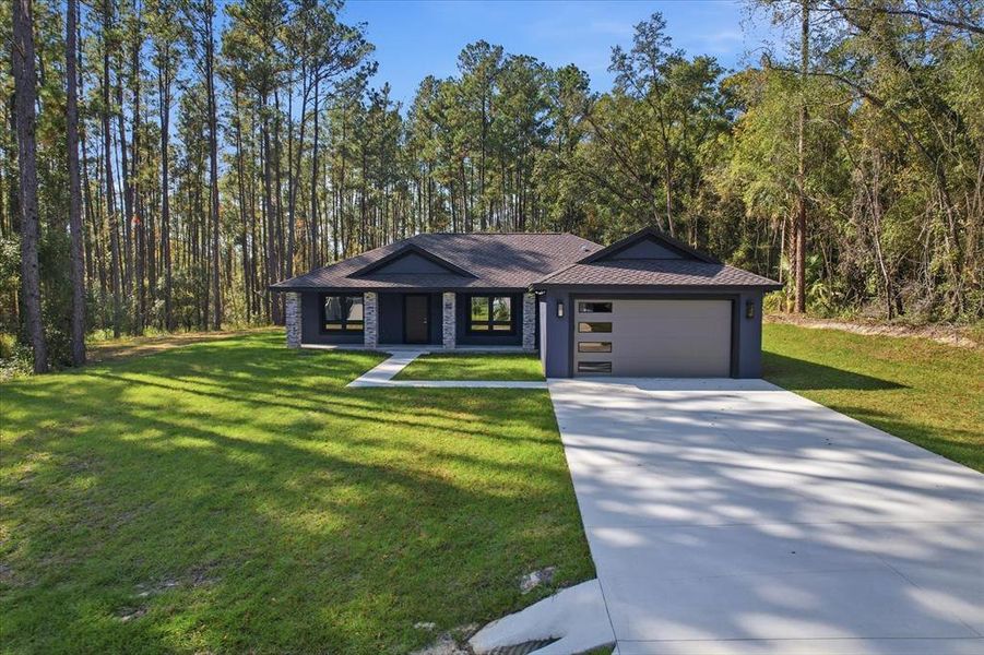 Front exterior of a new home in , Citrus Springs, FL, highlighting curb appeal (Image 28). Front exterior of a new home in , Citrus Springs, FL, highlighting curb appeal (Image 28).