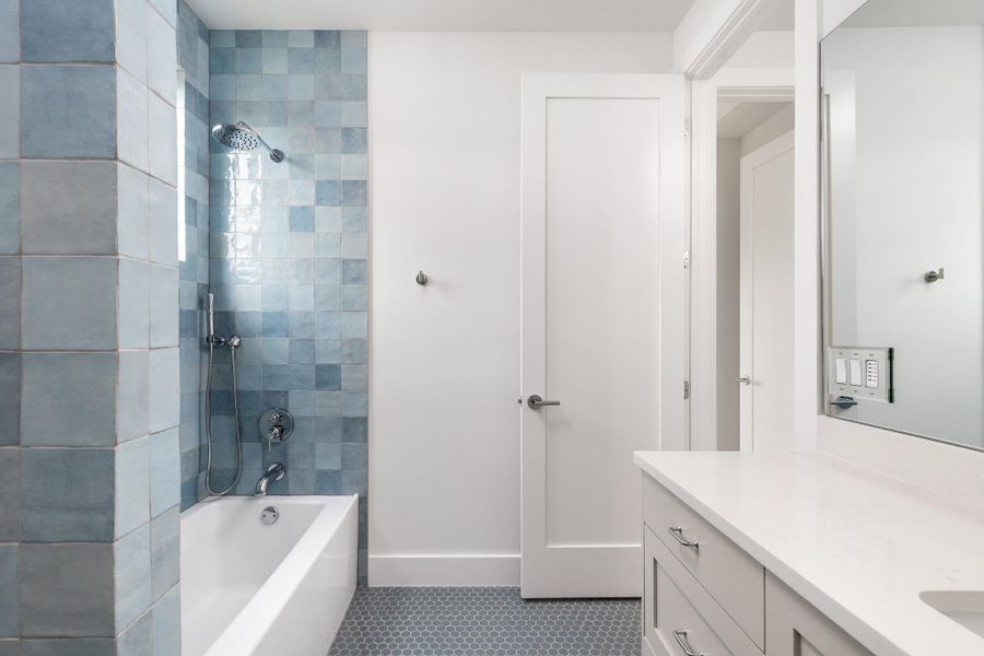 Bathroom with shower / bathtub combination and vanity