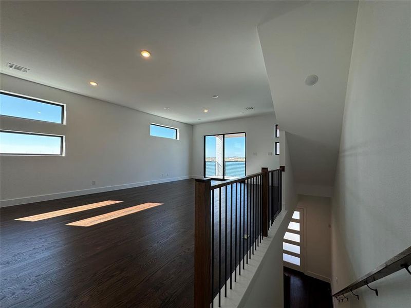 Empty room with dark hardwood / wood-style flooring