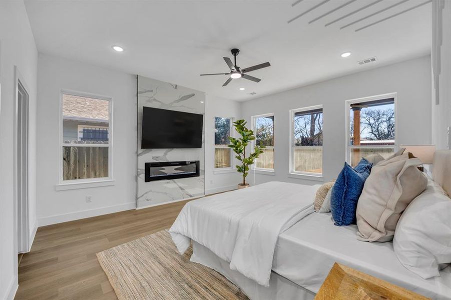 Bedroom with ceiling fan and light hardwood / wood-style flooring