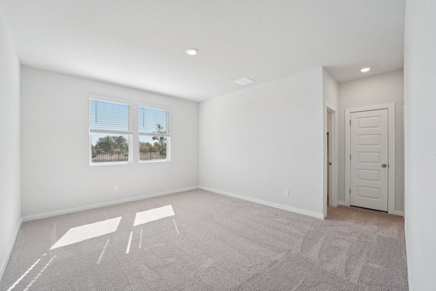 A room with white walls and a window.