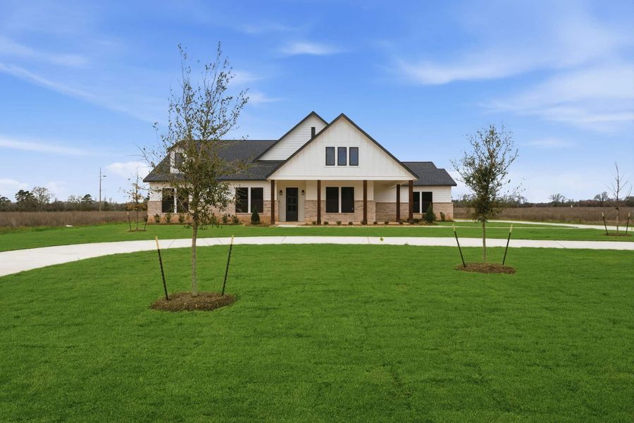 Front exterior of a new home in The Manors, New Waverly, TX, highlighting curb appeal (Image 23). Front exterior of a new home in The Manors, New Waverly, TX, highlighting curb appeal (Image 23).