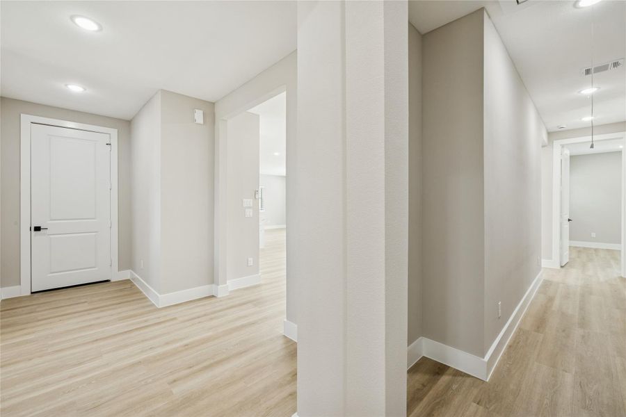 Elegant hallway leading to the spacious primary bedroom.