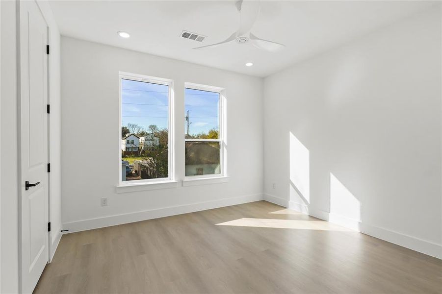 Unfurnished room with light wood-style floors, a ceiling fan, and recessed lighting