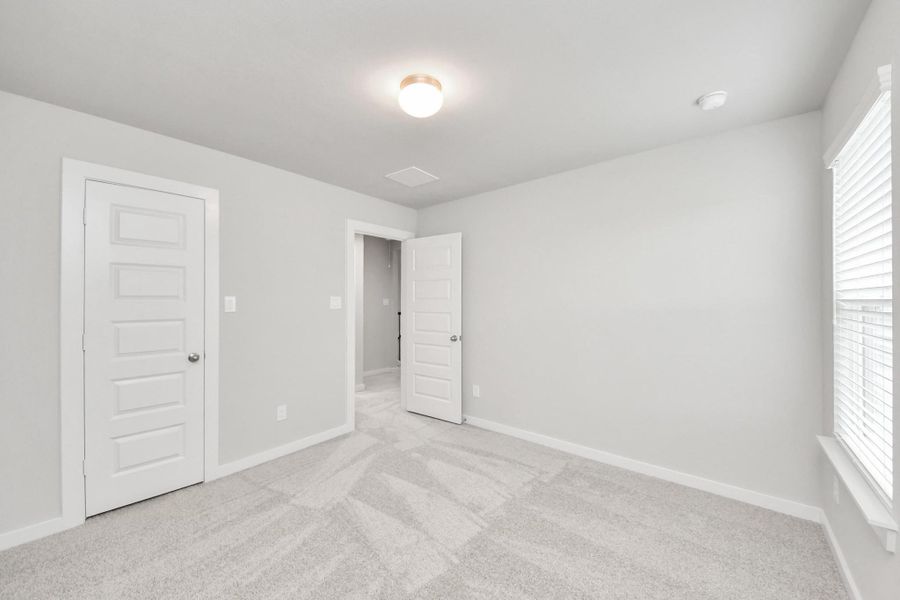 Generously sized secondary bedrooms featuring spacious closets, soft and inviting carpeting underfoot, large windows allowing plenty of natural light, and the added touch of privacy blinds for your personal retreat.