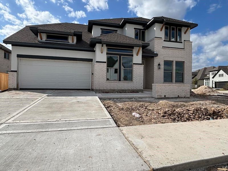 Front exterior of a new home in Bridgeland 55', Cypress, TX, highlighting curb appeal (Image 2). Front exterior of a new home in Bridgeland 55', Cypress, TX, highlighting curb appeal (Image 2).