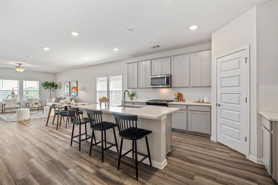The Kitchen offers lots of cabinet space and a large center island. The Kitchen offers lots of cabinet space and a large center island.