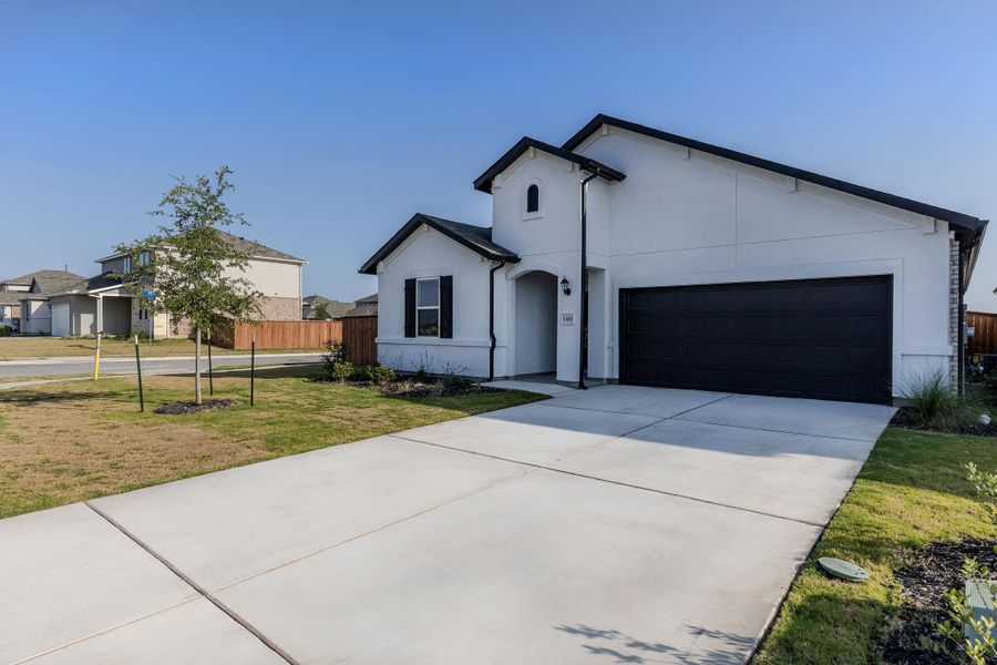 Front exterior of a new home in Lisso, Pflugerville, TX, highlighting curb appeal (Image 26). Front exterior of a new home in Lisso, Pflugerville, TX, highlighting curb appeal (Image 26).