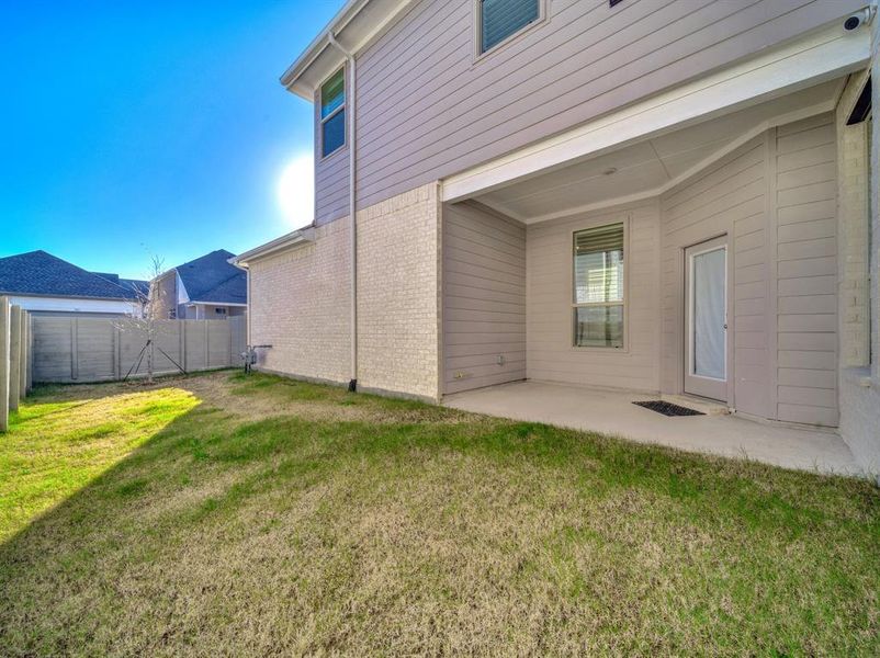 Rear view of property with a patio area and a yard