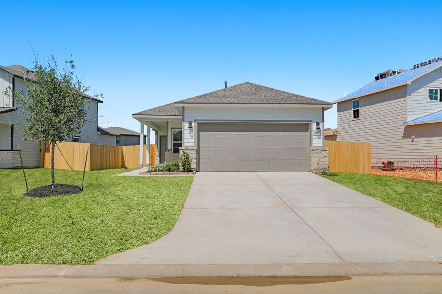 Front exterior of a new home in Lonestar Collection at Granger Pines, Conroe, TX, highlighting curb appeal (Image 21).