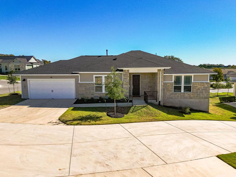 Ranch-style home with stone siding, driveway, a front yard, a shingled roof, and a garage Ranch-style home with stone siding, driveway, a front yard, a shingled roof, and a garage