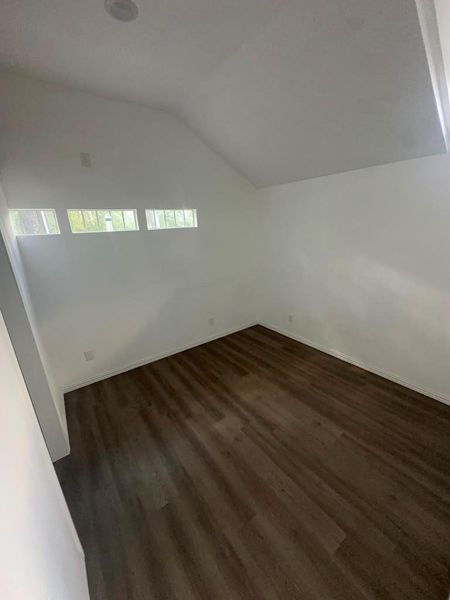 The rich hardwood floors complement the angular ceilings in this versatile space.