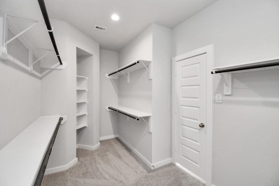 Walk-in closet that epitomizes luxury and practicality. This generously sized space features built-in shelving, offering abundant room for impeccable organization. High ceilings and recessed lighting create a bright and welcoming ambiance. Walk-in closet that epitomizes luxury and practicality. This generously sized space features built-in shelving, offering abundant room for impeccable organization. High ceilings and recessed lighting create a bright and welcoming ambiance.