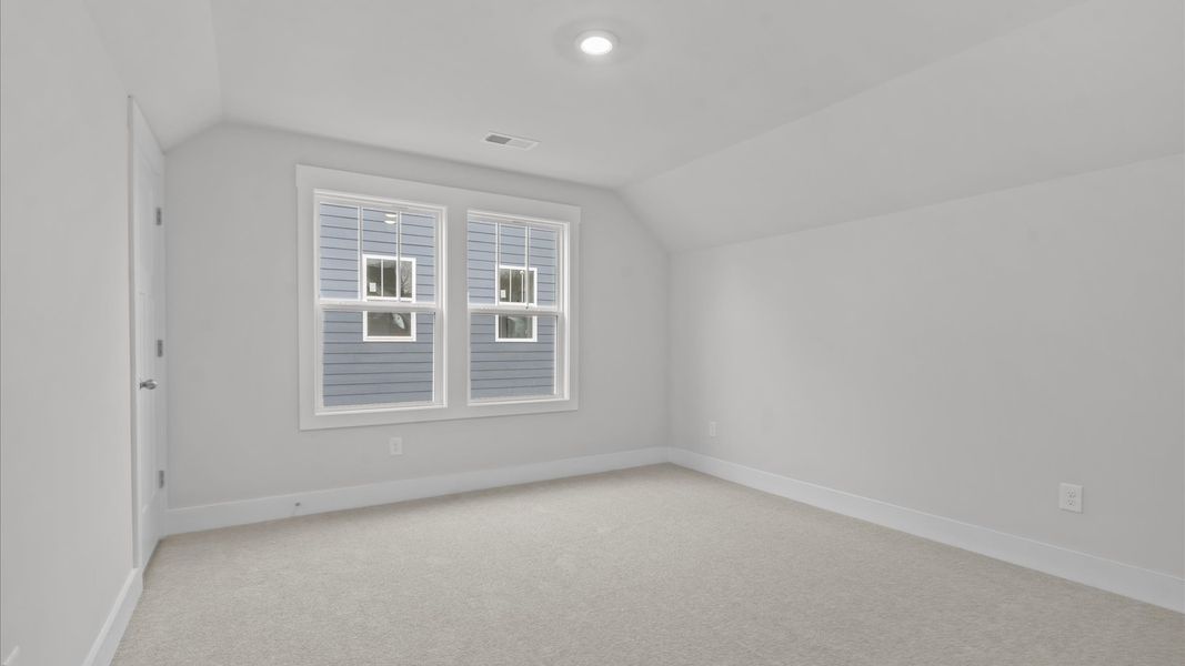 Memorable space with walk-in closet, soft carpeting, and striking natural light from large windows