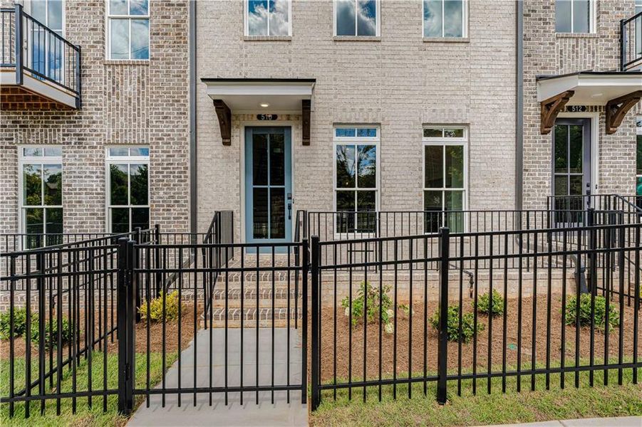 Exterior details and patio area of a home in Ward's Crossing Townhomes, Johns Creek (Image 3).