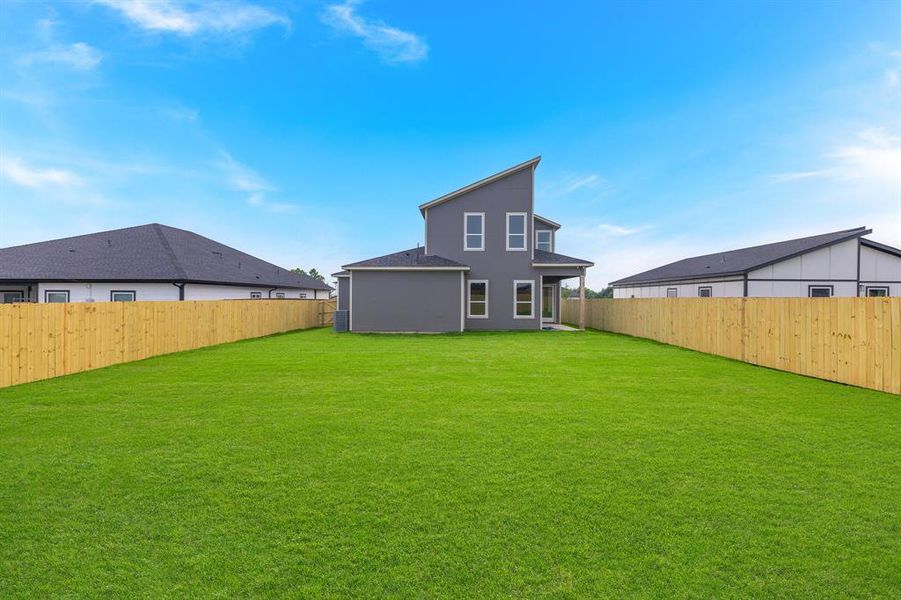Back of house with a fenced backyard
