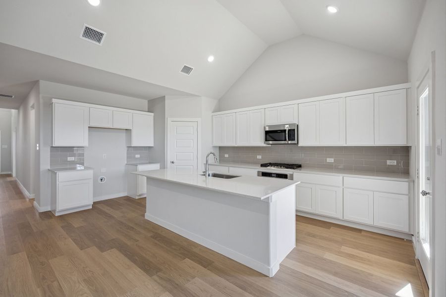 Kitchen in the Wimbledon home plan by Trophy Signature Homes – REPRESENTATIVE PHOTO