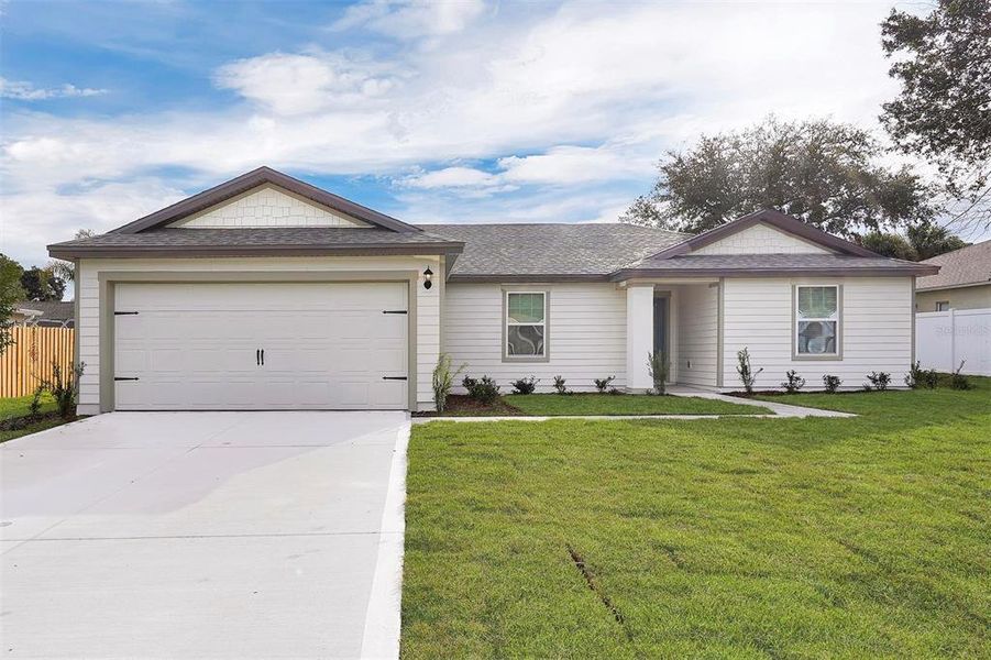 Front exterior of a new home in Palm Coast, Palm Coast, FL, highlighting curb appeal (Image 1). Front exterior of a new home in Palm Coast, Palm Coast, FL, highlighting curb appeal (Image 1).