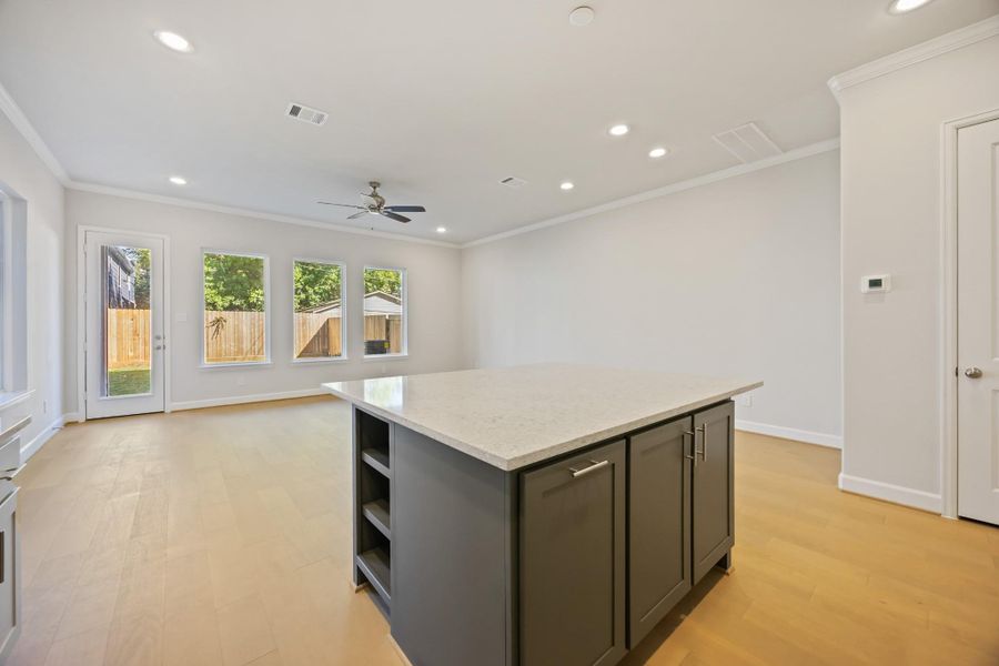 This huge island offers adjustable shelves, perfect for storing cookbooks or frequently accessed items, while providing a stunning view of the entire open-concept first-floor living space. This huge island offers adjustable shelves, perfect for storing cookbooks or frequently accessed items, while providing a stunning view of the entire open-concept first-floor living space.