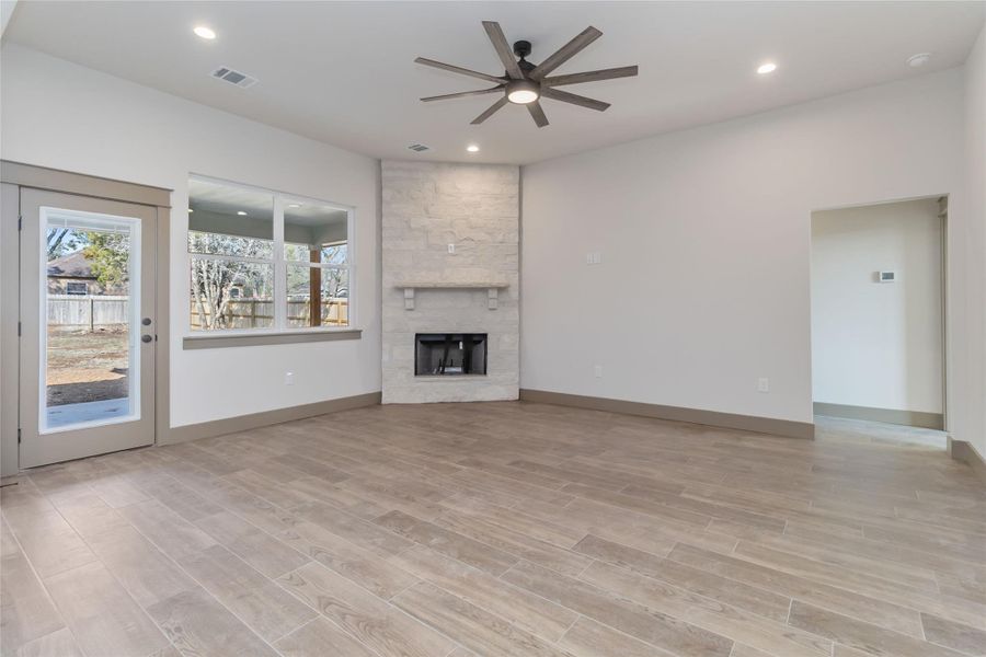 Wood burning fireplace with views of the back patio